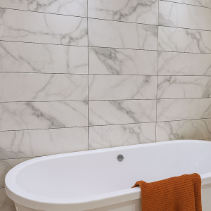 Gemma Valentina White Wall Tile on the wall with a bathtub